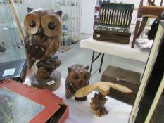 A large carved wooden owl and 2 others