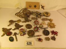 A quantity of military items including cap badgers, insignia,