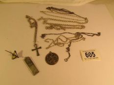 A silver cross on chain, a silver ingot, a silver St.