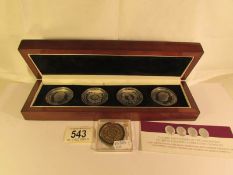 A cased set of 4 Elizabeth II 60th anniversary coronation silver crowns and one other coin