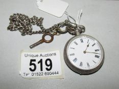 A silver fob watch on chain