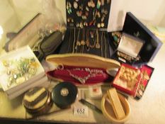 A mixed lot of costume jewellery including necklaces, cuff links, tie pins,