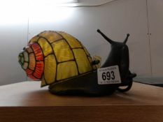 A bronzed cast iron Tiffany style table lamp as a snail