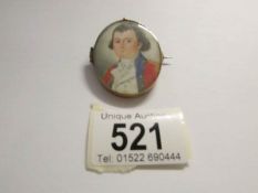 A 19th century miniature portrait pendant with hair in reverse and inscribed round edge William