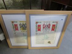 A pair of framed and glazed family crests