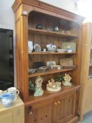 A good quality pine bookcase with cupboard base