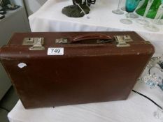 A small vintage leather suitcase