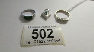 A diamond and emerald pendant and 2 dress rings,