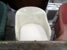 A white Lloyd loom style chair