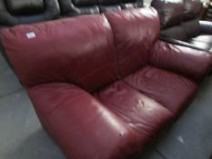 A red leather 2 seat sofa