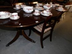 An oval extending dining table and 5 chairs