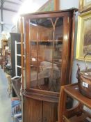 A mahogany effect corner cabinet