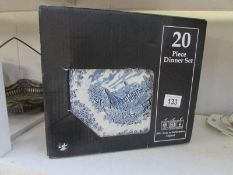 A boxed 20 piece blue and white dinner set