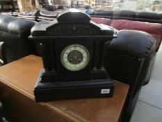 A 19th century black marble mantel clock