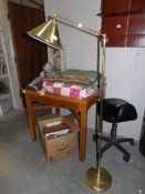 A brass floor standing adjustable reading lamp