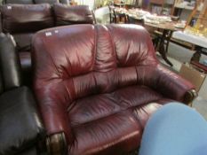 A 2 seat red leather sofa