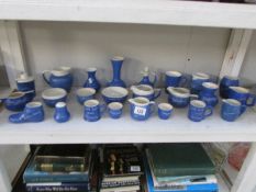A shelf of souvenir pottery