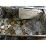 A tin containing foreign coins and bank notes