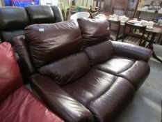 A 2 seat brown leather sofa