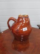 A treacle glazed art pottery jug