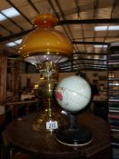 An oil lamp and a tin plate globe