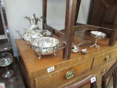 A silver plate teapot, water jug, dishes and ladles.