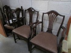 A mahogany carver chair and 4 dining chairs