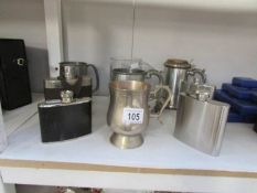 A quantity of tankards and hip flasks