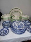 A quantity of blue and white plates and green and white dinner ware
