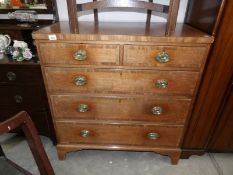 A 2 over 3 oak chest of drawers with brass handles