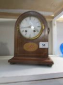 A mahogany inlaid clock