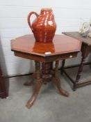 A mahogany octagonal table on birdcage base