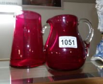 2 cranberry glass jugs