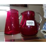 2 cranberry glass jugs