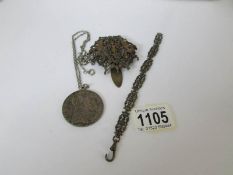 A silver coin pendant and 2 other items