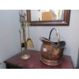 A copper coal scuttle and a brass companion set