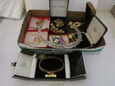 A mixed lot of costume jewellery including 18ct gold plated gate bracelet, brooches,