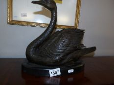 A bronze figure of a swan