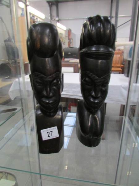 A pair of carved hard wood African native heads