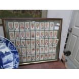 A framed and glazed set of Player's cricketer cigarette cards