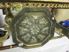 An oriental brass plaque