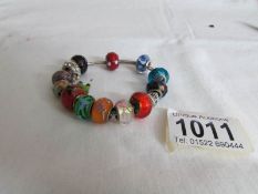 A quantity of charms including silver on a Pandora bracelet