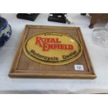 A waxed pine mounted cast iron Royal Enfield sign