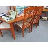 A teak table and 6 chairs