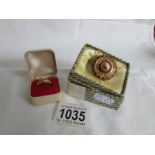 An 18ct gold ring (2 stones missing) HM Birmingham 1945 and a yellow metal brooch with safety chain