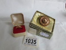 An 18ct gold ring (2 stones missing) HM Birmingham 1945 and a yellow metal brooch with safety chain