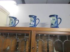 A set of 3 blue willow pattern jugs,