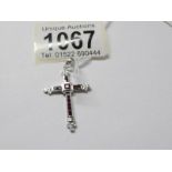 A 9ct white gold diamond and ruby set cross pendant