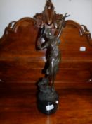 A bronze figure of a dancer