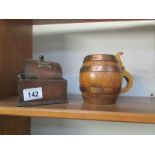 A tobacco jar in the shape of a barrel and an oak cigarette dispenser
